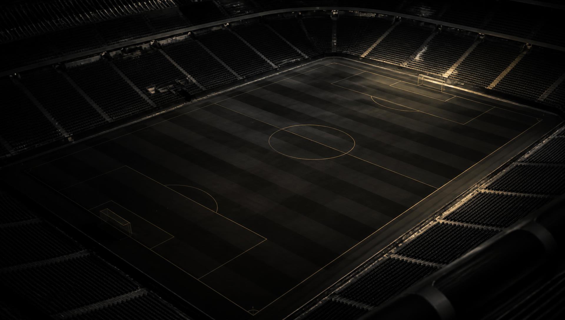 Aerial view of an empty football pitch under stadium lights